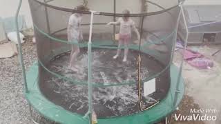 Hannah & Sophie Trimble playing on slippy trampoline in reverse