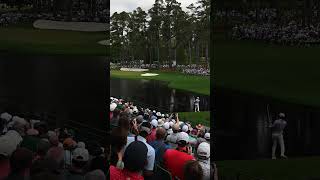 Scottie Scheffler skipping a golf ball onto the green at the Masters during practice round.