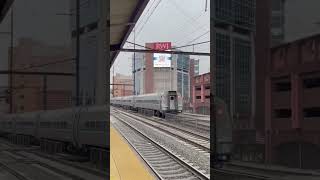 Amtrak Northeast Regional train speeding past New Brunswick Station