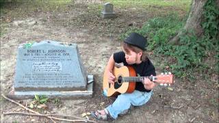 Blues artist Vidar "Viddi" Letho visiting Robert L. Johnson's grave