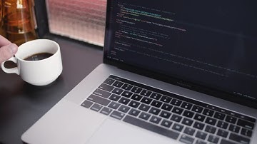 Software developer working while drinks coffee HD Video