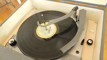Columbia record player, Circa 1958 playing a couple LP records.