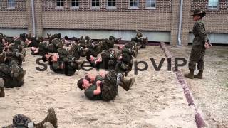 A Female drill instructor makes female Marine recruits ex...