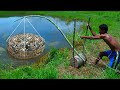 Primitive technology  making trap to catch catfish using bamboo to lure fish trap work 100