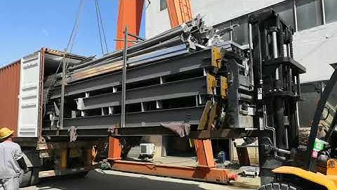 loading steel structure into shipping container with tray
