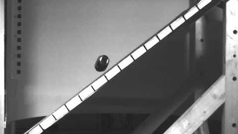 Elongate rock runout with rotation about smallest axis of inertia.