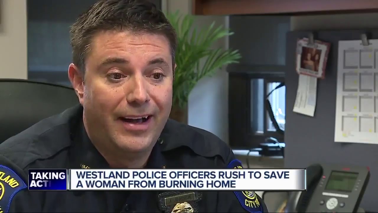 Westland police officers rush to save woman from burning home - YouTube