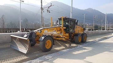 Motor Grader Grading Narrow Section On The Railroad-Skilled Operator