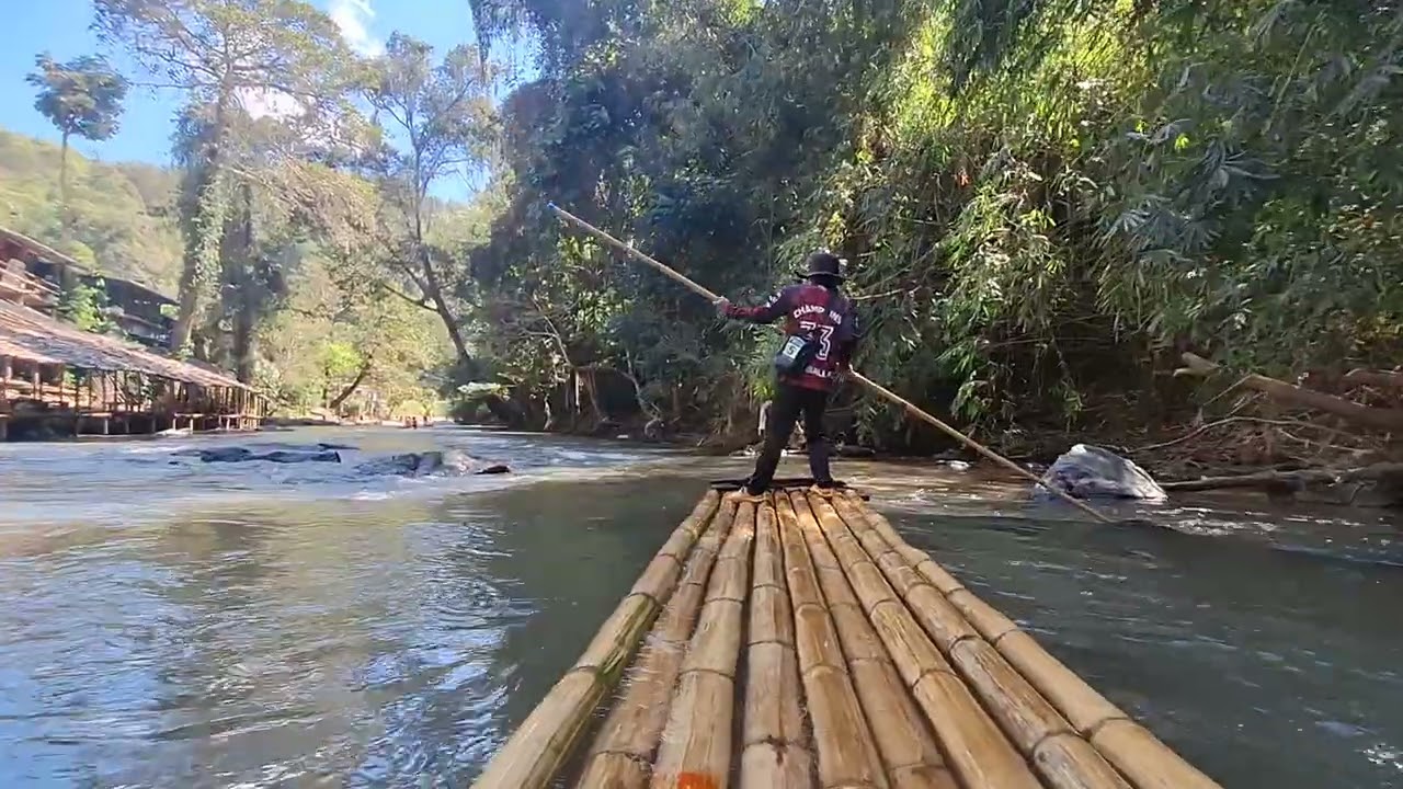 Bamboo rafting through the river at Chiang Mai mountains.