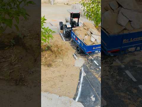 Rc Eicher tractor pulling loaded trolley of concrete waste