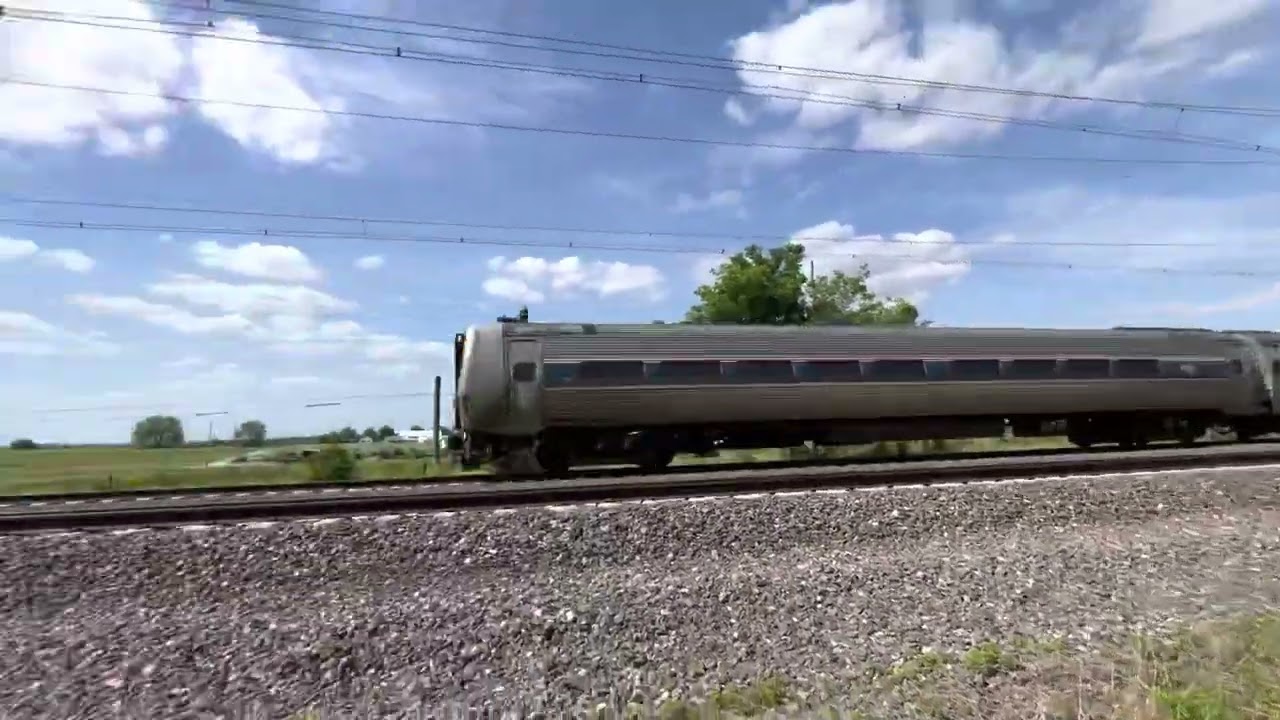 Amtrak 609 passing archery shop cab car 9647 leading and ACS-64 638 trailing
