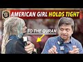 American girl holds tight to the quran speakers corner