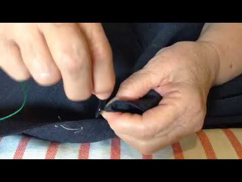 Sewing a button back on a suit jacket 