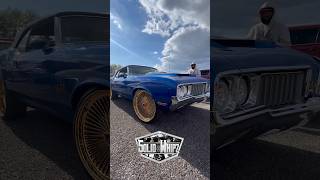 Oldsmobile Cutlass on 24” gold Dayton wire wheels