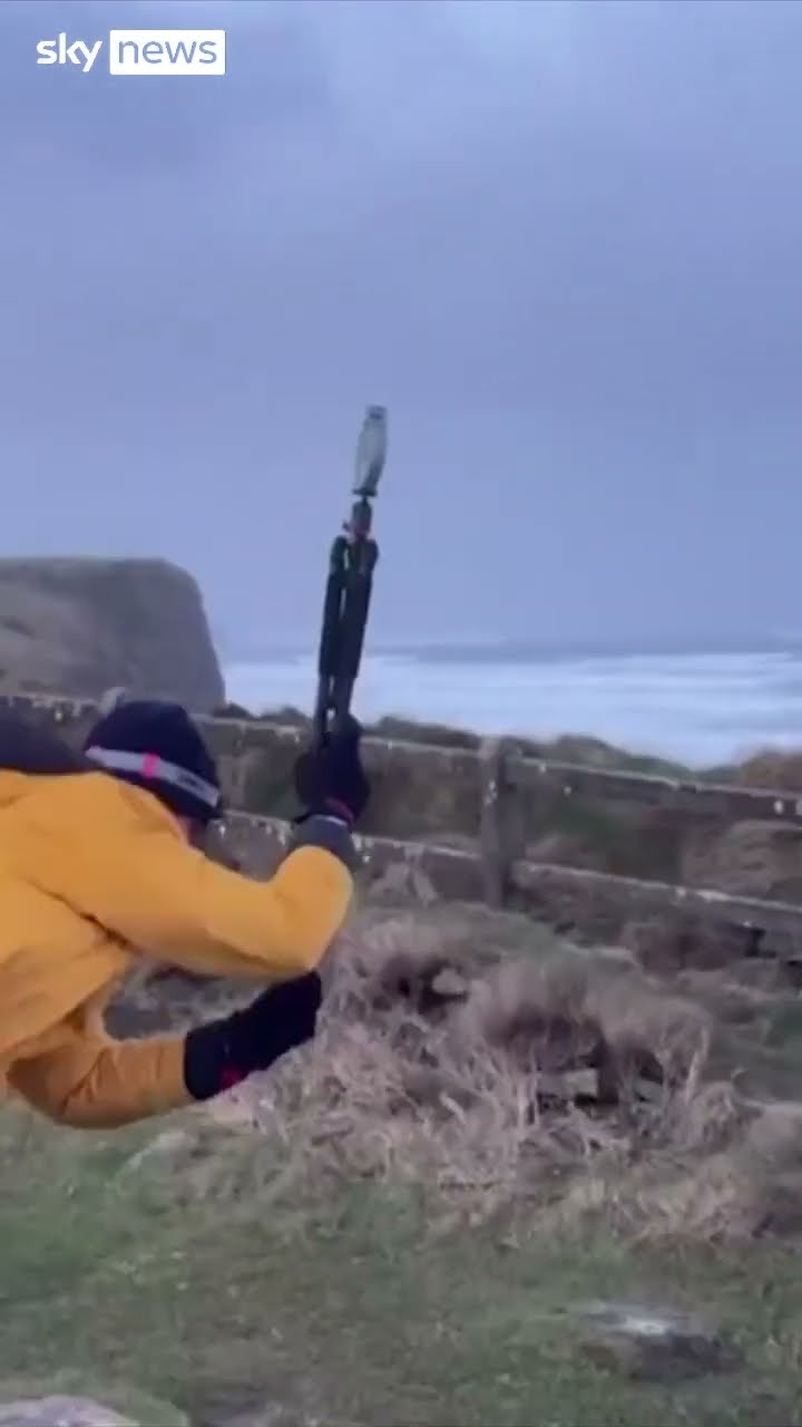 Man battles fierce gusts to measure wind speed