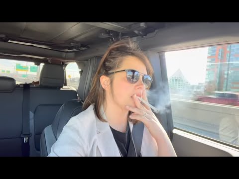 Woman Driving while Smoking and Chatting