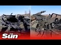 Ukrainian soldier shows off remains of destroyed Russian battle tank