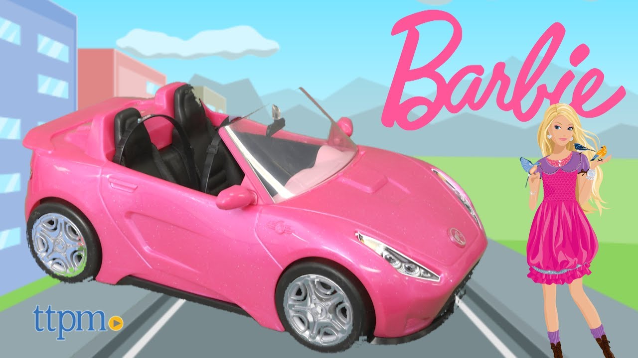 barbie doll and pink convertible