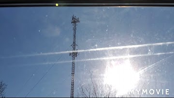 A cell tower with a dual strobe on the edge of the top platform