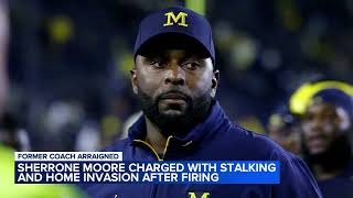 Fired University of Michigan football coach charged with home invasion, stalking
