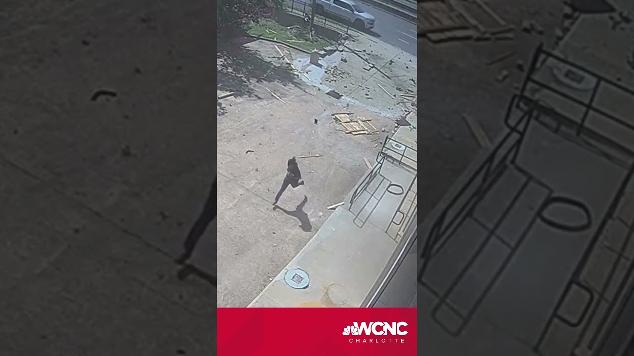 Wow! Car crashes and flips through fence into building 