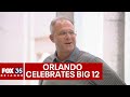 Ucf football coach gus malzahn mayor buddy dyer raise ucf flag outside orlando city hall