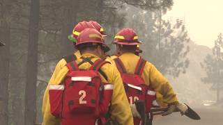 Firefighters protecting homes