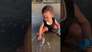 Sudden Wave Surprises a Child While Playing on the Beach