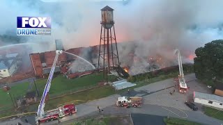 Crews may be battling fire at warehouse for several days