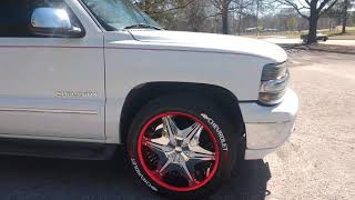 02 suburban with red chrome wrap rims and chevrolet tire stickers