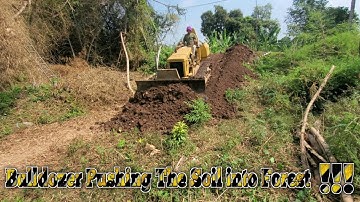 Wonderful Bulldozer Pushing The Soil Down From Stone Road into bamboo forest With Dump truck working