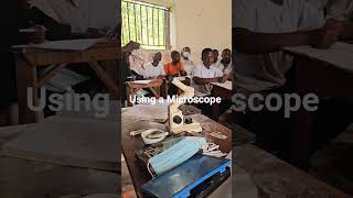 students experience using the #microscope  at Kasese Municipal High Humanist School