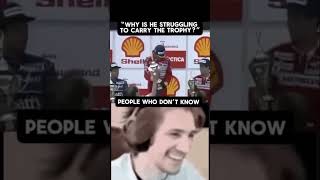 Why is he struggling to carry the trophy?
