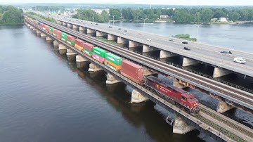 Awesome Aerial 4K View! Big Fast Stack Train CPKC 119 w/DPU Crossing Bridge at Dorion, Quebec