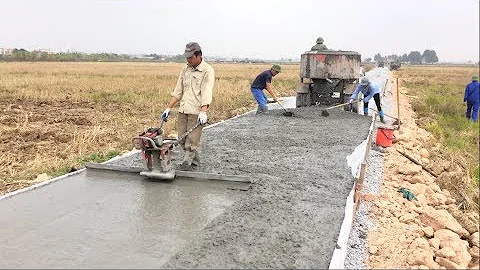 Construction A Concrete Road Stretching On Rural Fields With Ready-Mixed Concrete