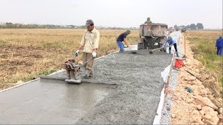 Construction A Concrete Road Stretching On Rural Fields With Ready-Mixed Concrete