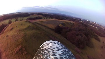 Multiplex Easystar II RC plane flying from a small hill at sunset