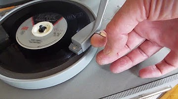 Columbia portable 4 speed record player playing a 45 RPM record