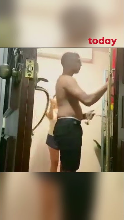 Woman bangs on gong while neighbour performs prayer ritual