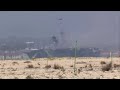 Helicopters taking aim at fire aboard USS Bonhomme Richard at Naval Base San Diego