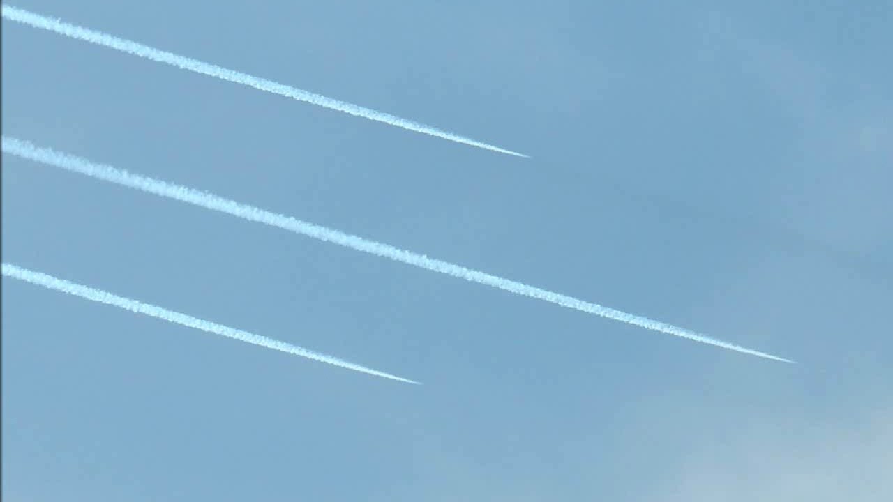 Airplanes flying in formation far away. Looks like it is 2 groups with