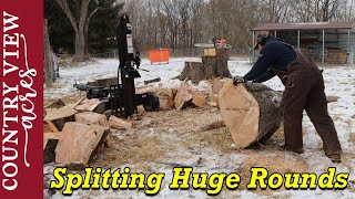 Splitting Huge rounds of wood.  Some are too big to handle.