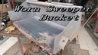 Worn Skidsteer Sweeper bucket