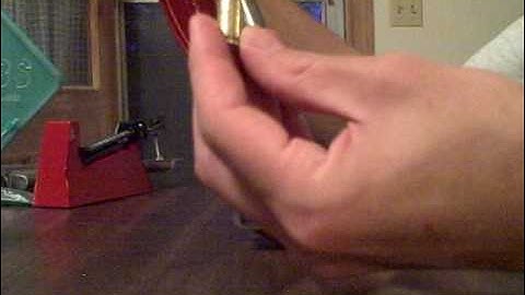 Seating the bullet and crimping the case.
