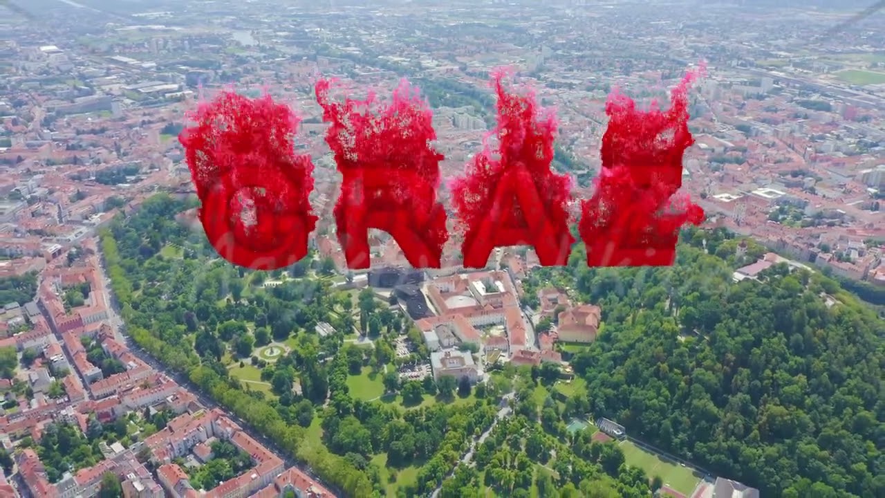 Inscription on video. Graz, Austria. The historic city center aerial view. Mount Schlossberg (Castle