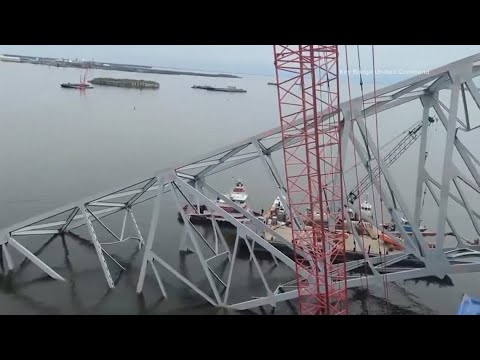 Salvage crews work to remove large section of Francis Scott Key Bridge from atop cargo ship