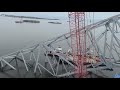 Salvage crews work to remove large section of Francis Scott Key Bridge from atop cargo ship