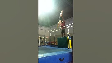Ryan doing a double back off the parallel bars