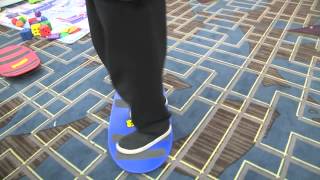Stewart Demonstrates the Penguin Walk Using a Spooner Board and a Spikeball Ball