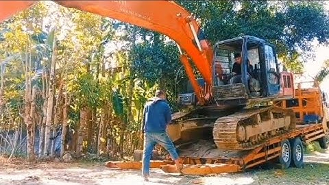Process of Loading and Unloading an Excavator onto a Self-Loader Truck